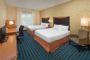 a hotel room with two beds and a television at Fairfield Inn and Suites Cleveland in Cleveland