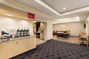 a lobby of a hotel with a waiting area and a restaurant at TownePlace Suites by Marriott Chattanooga Near Hamilton Place in Chattanooga