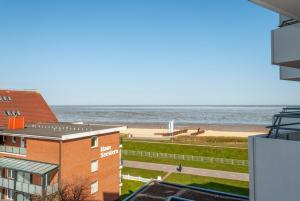 a view of the beach from the balcony of a building at Haus Hanseatic, Wohnung 501 in Duhnen