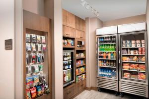 a kitchen with two refrigerators and food and drinks at Residence Inn by Marriott Baltimore Owings Mills in Owings Mills