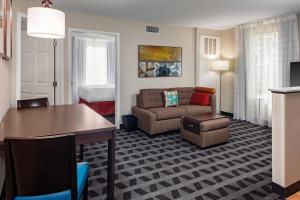 a living room with a couch and a table at TownePlace Suites by Marriott Dallas Plano/Legacy in Plano