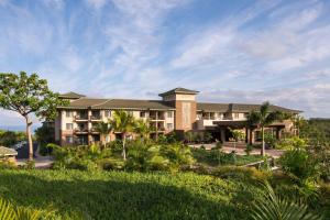 an exterior view of a resort with palm trees at Residence Inn by Marriott Maui Wailea in Wailea