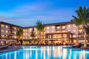 a hotel with a swimming pool at night at Residence Inn by Marriott Maui Wailea in Wailea