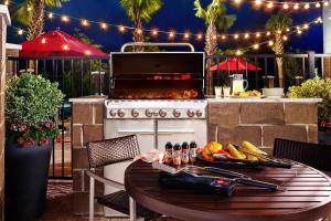 a outdoor kitchen with a table and a grill at TownePlace Suites Atlanta Lawrenceville in Lawrenceville