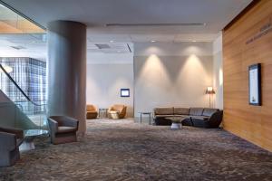 a lobby with couches and chairs in a building at The Westin Galleria Dallas in Dallas