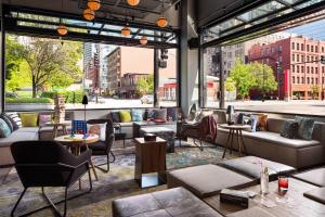 a lobby with couches and tables and a large window at Moxy Chicago Downtown in Chicago