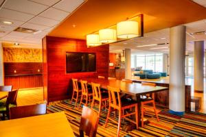 a dining room with a large wooden table and chairs at Fairfield Inn & Suites by Marriott Princeton in Princeton