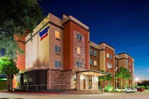 a hotel building with a sign on the side of it at Fairfield Inn & Suites Houston Hobby Airport in Houston