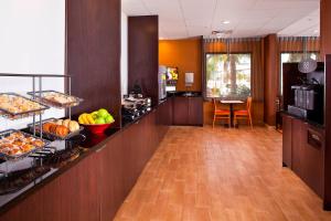 a kitchen with a counter with food on it at Fairfield Inn & Suites Houston Hobby Airport in Houston