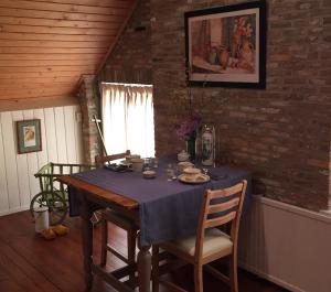 a dining room table with a blue table cloth on it at Droomgaerd in Vlist