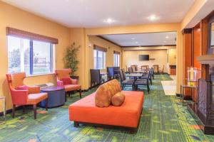 a waiting room at a hospital with an orange couch and chairs at Fairfield Inn & Suites Billings in Billings