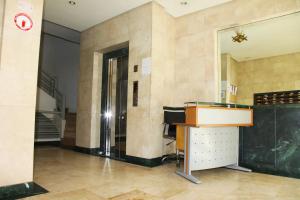 a lobby with a desk and a staircase in a building at Appartement Haut Standing Central Corniche in Tangier