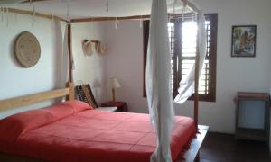 Кровать или кровати в номере Villa Lagosta no Abacaxi