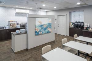 a restaurant with tables and a counter with a picture on the wall at Residence Inn Boston Westford in Westford