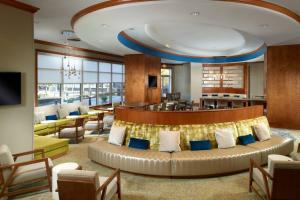 a hotel lobby with a couch and a bar at SpringHill Suites by Marriott Atlanta Buckhead in Atlanta