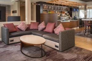 a living room with a couch and a table at Courtyard by Marriott Dulles Airport Chantilly in Chantilly