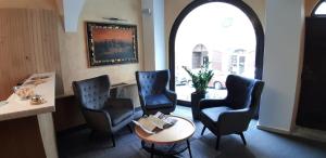 a waiting room with two chairs and a table at The Golden Wheel Hotel in Prague