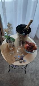 a table with a bowl of fruit and a bowl of wine glasses at The Golden Wheel Hotel in Prague