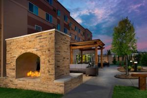 a brick fireplace in front of a building at Courtyard Houston NW/290 Corridor in Houston