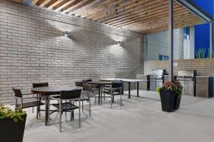 a patio with tables and chairs and a brick wall at TownePlace Suites by Marriott Columbus Dublin in Dublin