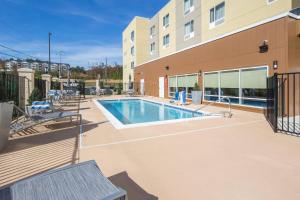 a swimming pool in front of a building at TownePlace Suites by Marriott Cleveland in Cleveland