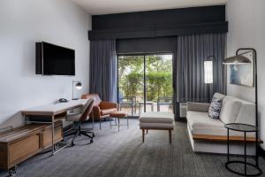 a living room with a couch and a desk at Courtyard by Marriott Denver Golden/Red Rocks in Golden