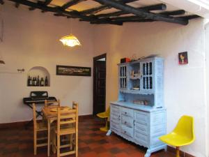 a dining room with a table and a blue cabinet at Casa Yerbabuena- Rustiko in Barichara