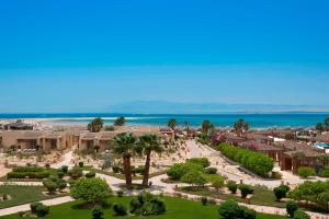 a view of a park with trees and the ocean at Sheraton Soma Bay Resort in Hurghada