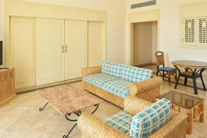 a living room with a couch and chairs and a table at Sheraton Soma Bay Resort in Hurghada