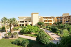a view of a building with trees and bushes at Sheraton Soma Bay Resort in Hurghada