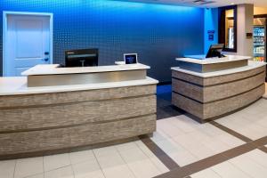 a cashier counter in a store with a blue wall at Residence Inn by Marriott Jacksonville South Bartram Park in Jacksonville