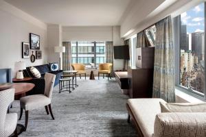 a hotel room with a living room with a view of a city at The Ritz-Carlton, Boston in Boston