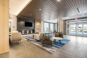 a lobby with a waiting area with chairs and a table at Fairfield Inn & Suites by Marriott Dallas Plano/Frisco in Plano