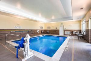 a pool in a hotel room with a swimming pool at Fairfield Inn & Suites by Marriott Dallas Plano/Frisco in Plano