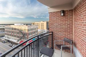 a balcony with chairs and a view of a city at Courtyard by Marriott Baton Rouge Downtown in Baton Rouge