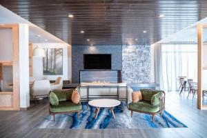 a living room with two chairs and a fireplace at Fairfield by Marriott Inn & Suites Kingsport in Kingsport