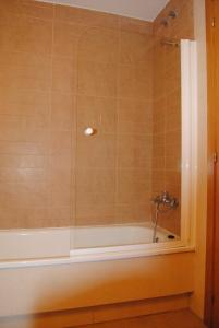 Das Bad ist mit einer Badewanne mit einer Dusche ausgestattet. in der Unterkunft Apartamentos Riveiro in Sanxenxo