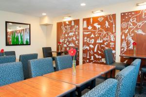 a conference room with a wooden table and chairs at TownePlace Suites Indianapolis Park 100 in Indianapolis