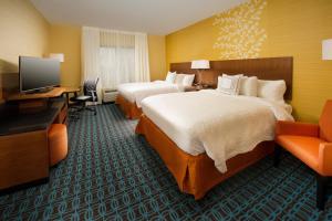 a hotel room with two beds and a television at Fairfield Inn & Suites by Marriott Arundel Mills BWI Airport in Hanover