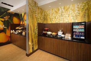 a restaurant with a counter with food on it at Fairfield Inn & Suites by Marriott Arundel Mills BWI Airport in Hanover