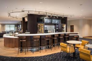 a bar in a hotel with stools and tables at Courtyard by Marriott Anaheim Resort/Convention Center in Anaheim