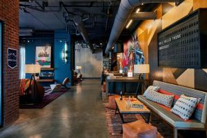 a lobby of a restaurant with a bench and a table at Moxy Chattanooga Downtown in Chattanooga