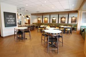 a dining room with tables and chairs in a restaurant at Fairfield Inn & Suites Winona in Winona