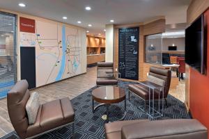 a lobby with chairs and a map on a wall at TownePlace Suites by Marriott Baton Rouge Port Allen in Port Allen