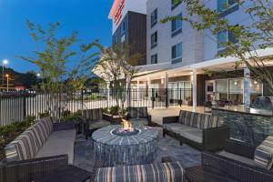 a patio with a fire pit in front of a building at TownePlace Suites by Marriott Baton Rouge Port Allen in Port Allen