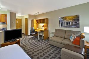 斯特林高地的住宿－底特律斯特林高地廣場套房酒店，客厅配有沙发和书桌。
