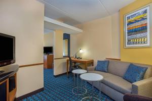 a living room with a couch and a tv at Fairfield Inn & Suites Kodak in Kodak