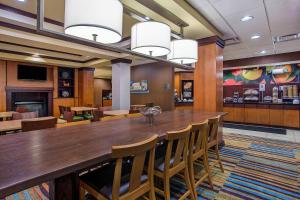 a large dining room with a large wooden table and chairs at Fairfield Inn & Suites Kodak in Kodak