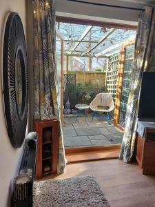 a living room with a view of a patio at ALVASTON, DERBY Entire 1 Bed House & South Facing Patio Garden in Derby