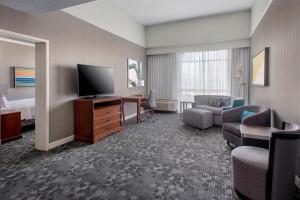 a hotel room with a bed and a television at Courtyard by Marriott Basking Ridge in Basking Ridge